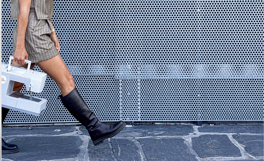 Bazwil with a sewing machine and a handmade outfit